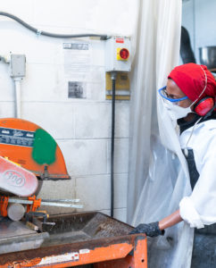 A person working inside the Advanced Cementitious Materials & Composites (ACMC) Laboratory