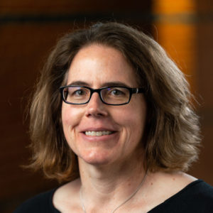Portrait of Dr. Christine Kirchhoff, a woman with shoulder-length light brown hair wearing black glasses and a black top.