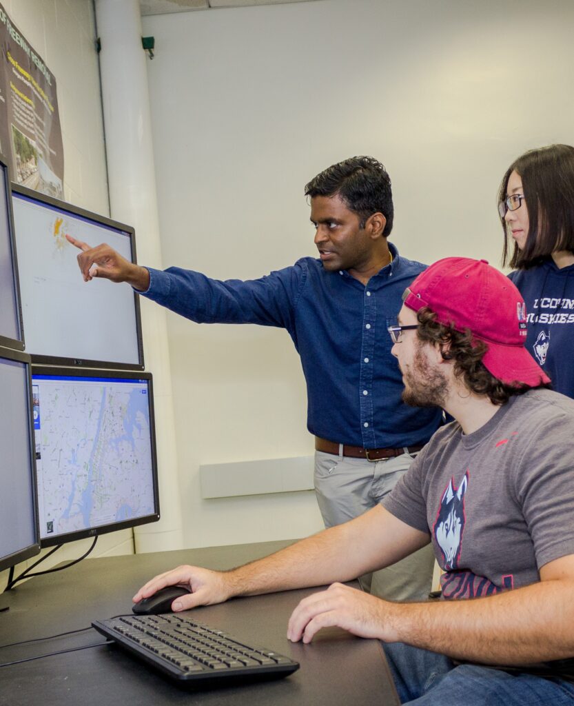 Professor working with two Transportation and Urban Engineering students