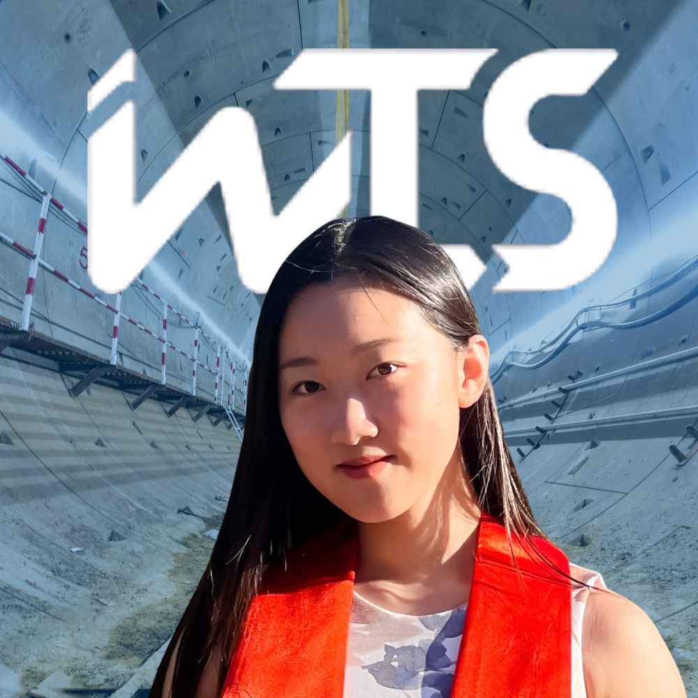 Ying Zhang in front of WTS logo and public transportation tunnel
